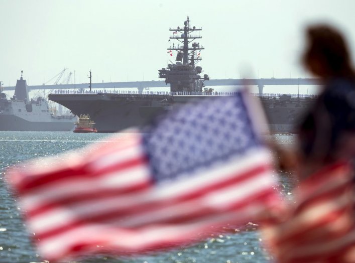 The USS Ronald Reagan, a Nimitz-class nuclear-powered super carrier, is followed by the USS Somerset as it departs for Yokosuka, Japan from Naval Station North Island in San Diego, California August 31, 2015. REUTERS/Mike Blake