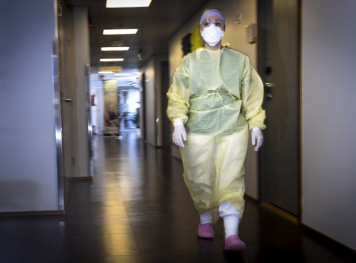  A nurse wearing protective equipment walks at a clinic in Vantaa, Finland March 26, 2020. Lehtikuva/Emmi Korhonen via REUTERS