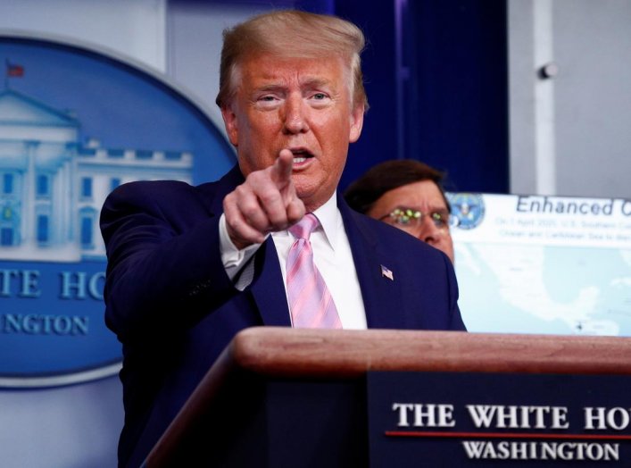 U.S. President Donald Trump addresses the daily coronavirus response briefing as Defense Secretary Mark Esper listens at the White House in Washington, U.S., April 1, 2020. REUTERS/Tom Brenner