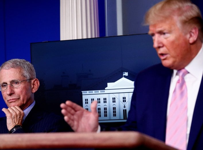 Dr. Anthony Fauci, director of the National Institute of Allergy and Infectious Diseases, listens as U.S. President Donald Trump addresses the daily coronavirus response briefing at the White House in Washington, U.S., April 1, 2020. REUTERS/Tom Brenner