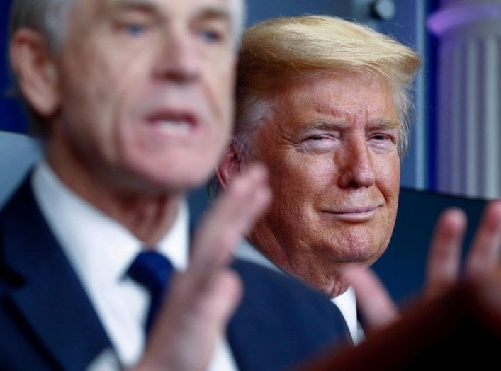 U.S. President Donald Trump listens as White House Director of Trade and Marketing Policy Peter Navarro addresses the daily coronavirus response briefing at the White House in Washington, U.S., April 2, 2020. REUTERS/Tom Brenner.