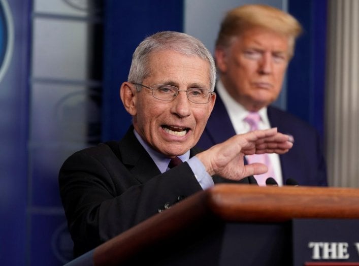 U.S. President Donald Trump listens as Dr. Anthony Fauci, director of the National Institute of Allergy and Infectious Diseases, addresses the daily coronavirus task force briefing at the White House in Washington, U.S., April 4, 2020. REUTERS/Joshua Robe