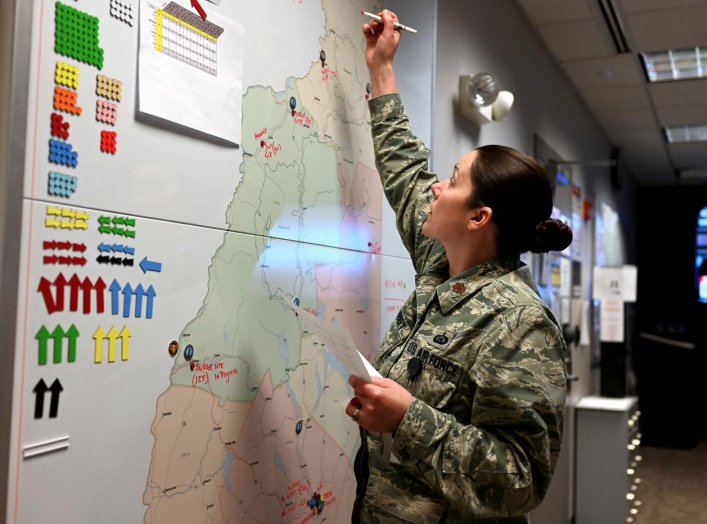 New Hampshire National Guard chief of operations Major Moira Cuthbert tracks coronavirus disease (COVID-19) missions at the Joint Operations Center in Concord, New Hampshire, U.S. April 2, 2020. Picture taken April 2, 2020. U.S. Air National Guard/Staff S