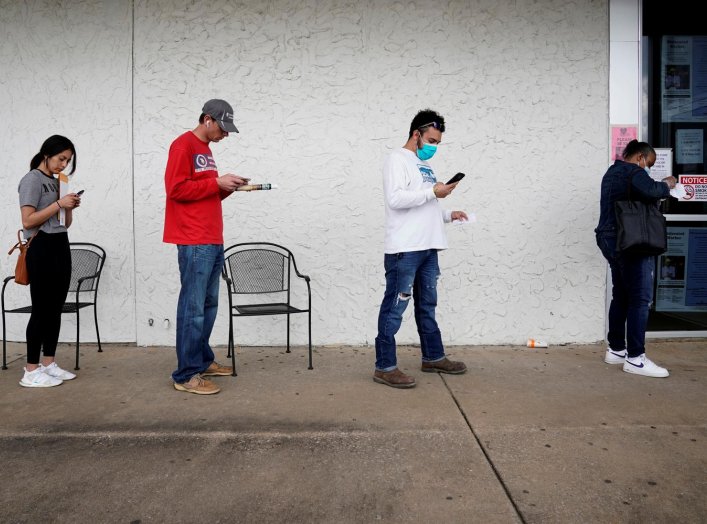 People who lost their jobs wait in line to file for unemployment following an outbreak of the coronavirus disease (COVID-19), at an Arkansas Workforce Center in Fayetteville, Arkansas, U.S. April 6, 2020. REUTERS/Nick Oxford