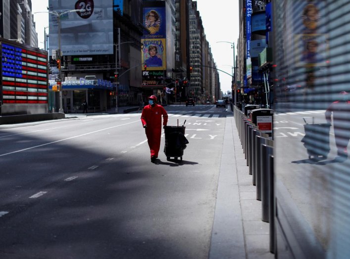 A Times Square Alliance street sweeper worker walks though a nearly empty Times Square in Manhattan during the outbreak of the coronavirus disease (COVID-19) in New York City, New York, U.S., April 7, 2020. REUTERS/Mike Segar
