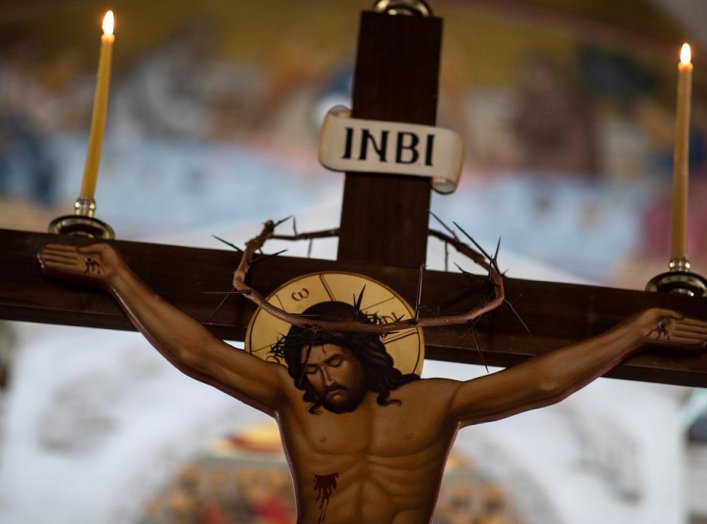 A crown of thorns is placed on a crucifix during the procession of Jesus Christ's Deposition from the Cross taking place in a church behind closed doors, as part of measures to contain the spread of the coronavirus disease (COVID-19) in Athens, Greece, Ap