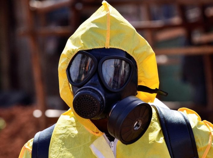 A Ugandan health official wearing protective gear prepares to disinfect the Nakawa open-air market as part of the measures to prevent the spread of the coronavirus disease (COVID-19), within in Nakawa division of Kampala, Uganda April 17, 2020. REUTERS/Ab