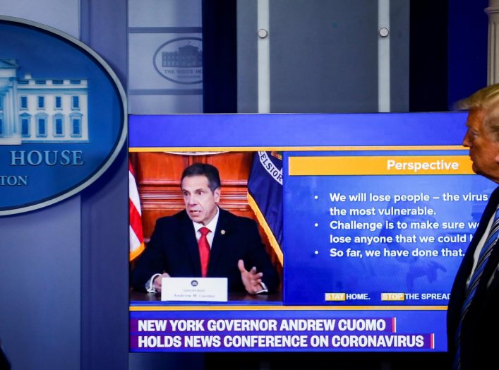 U.S. President Donald Trump and U.S. Vice President Mike Pence watch a video of New York governor Andrew Cuomo speaking at Cuomo's daily briefing, during the daily coronavirus disease (COVID-19) task force briefing at the White House in Washington, U.S., 