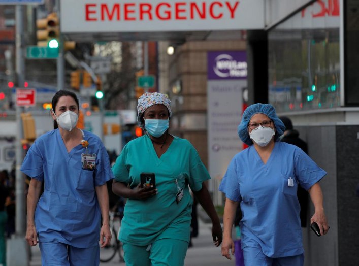 Healthcare workers walk outside NYU Langone Medical Center on 1st Avenue in Manhattan after people came to cheer and thank them, during the outbreak of the coronavirus disease (COVID-19) in New York City, New York, U.S., April 20, 2020. REUTERS/Brendan Mc