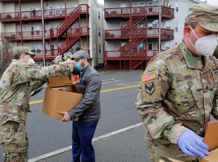 Members of the 101st Engineer Battalion of the Massachusetts Army National Guard distribute free groceries at a pop-up food pantry amid the coronavirus disease (COVID-19) outbreak in Chelsea, Massachusetts, U.S., April 24, 2020. REUTERS/Brian Snyder