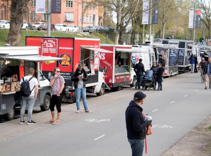 People buy food from food trucks amid the outbreak of the coronavirus disease (COVID-19), in Stockholm, Sweden April 26, 2020. Jessica Gow/TT News Agency/via REUTERS 