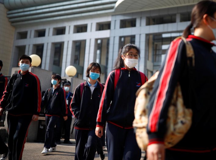 Students wearing face masks leave a school in Beijing, China as senior high school students in the Chinese capital returned to campus following the coronavirus disease (COVID-19) outbreak, April 27, 2020. REUTERS/Thomas Peter