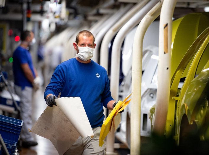 Workers wear protective masks at the Volkswagen assembly line after VW re-starts Europe's largest car factory after coronavirus shutdown in Wolfsburg, Germany, April 27, 2020, as the spread of the coronavirus disease (COVID-19) continues. Swen Pfoertner/P