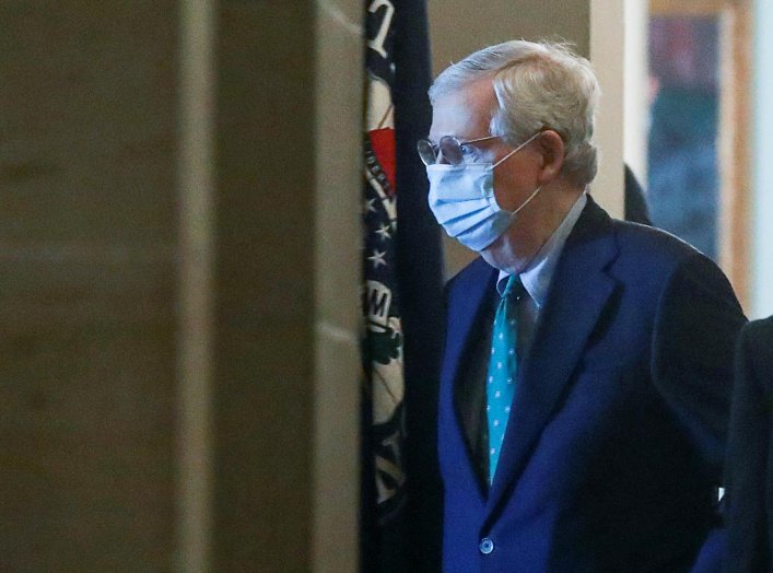 U.S. Senate Majority Leader Mitch McConnell (R-KY) wears a protective mask as he arrives at his office inside the U.S. Capitol after senators returned to Capitol Hill amid concerns that their legislative sessions could put lawmakers and staff at risk of c