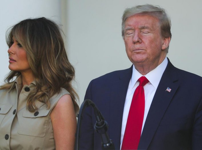 First lady Melania Trump stands with U.S. President Donald Trump as he closes his eyes during the White House National Day of Prayer Service in the Rose Garden at the White House in Washington, U.S., May 7, 2020. REUTERS/Tom Brenner