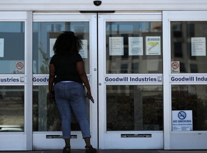 A woman looks for information on the application for unemployment support at the New Orleans Office of Workforce Development, as the spread of coronavirus disease (COVID-19) continues, in New Orleans, Louisiana U.S., April 13, 2020. REUTERS/Carlos Barria