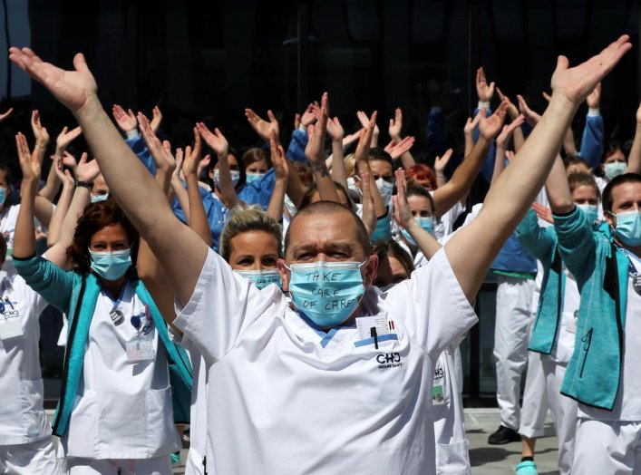 Healthcare workers, nurses and doctors, unified under the movement called "Take Care of Care" wearing face masks protest against the Belgian authorities' management of the coronavirus disease (COVID-19) crisis, at the MontLegia CHC Hospital in Liege, Belg