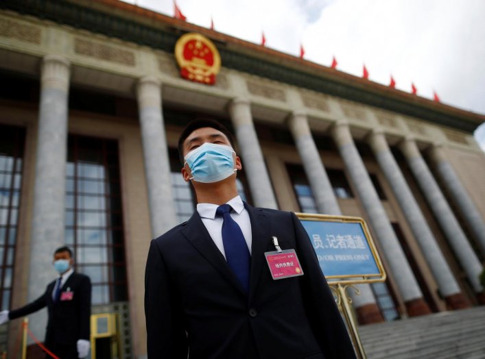 Security personnel wearing face masks following the coronavirus disease (COVID-19) outbreak stand guard outside the Great Hall of the People before the second plenary session of the National People's Congress (NPC) in Beijing, China May 25, 2020. REUTERS/