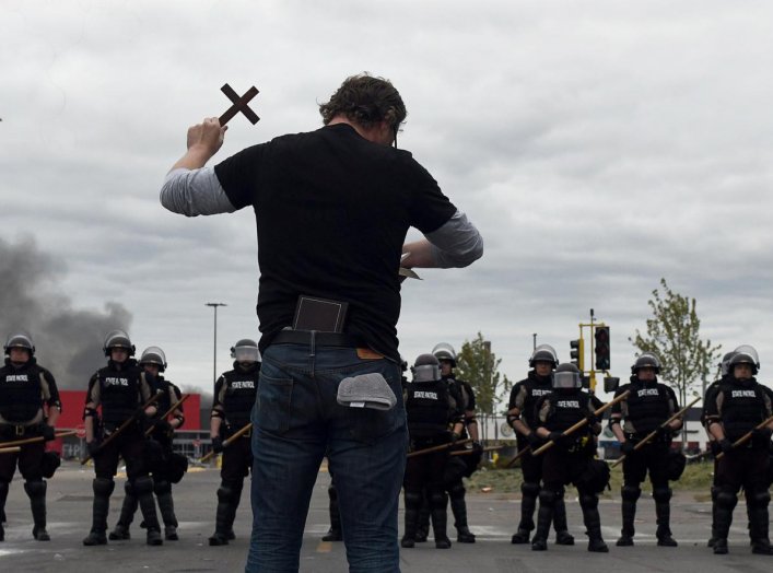 A Minneapolis resident who declined to be identified preaches through tears at State Police blocking access to the area near the Minneapolis Police third precinct following the third day of demonstrations in response to the death of African-American man G