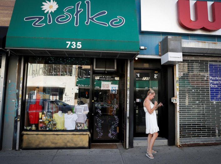 Beata Widziszewski, owner of Backstage Boutique clothing store which has been closed for three months, takes a break outside her shop as the phase one reopening of New York City continues during the outbreak of the coronavirus disease (COVID-19) in the Br