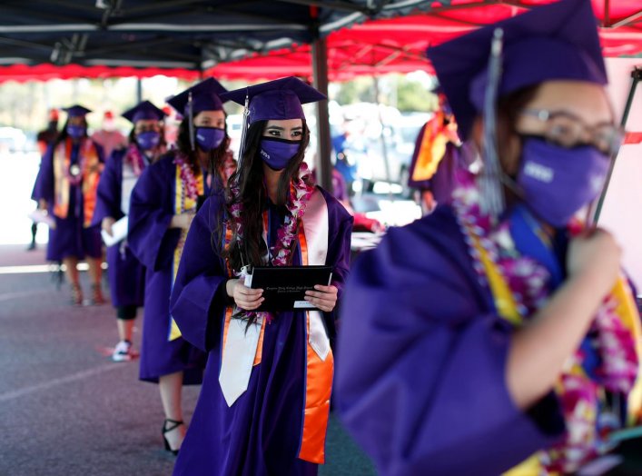 Compton Early College High School graduating students wait after picking up their diplomas in a parking lot during a drive-thru graduating ceremony, during the outbreak of the coronavirus disease (COVID-19) in Compton, California U.S. June 10, 2020. REUTE