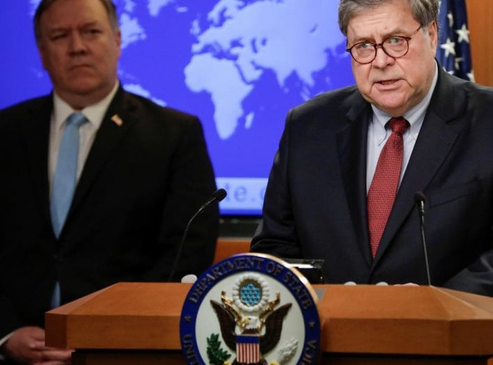 U.S. Attorney General Bill Barr speaks as Secretary of State Mike Pompeo listens during a joint briefing about an executive order from U.S. President Donald Trump on the International Criminal Court at the State Department in Washington, U.S., June 11, 20
