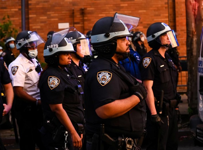 The NYPD watches as demonstrators protest against the racial inequality in the aftermath of the death in Minneapolis police custody of George Floyd, in New York City, New York, U.S. June 11, 2020. Picture taken June 11, 2020. REUTERS/Idris Solomon