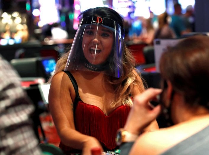 A blackjack dealer wears a face shield during the reopening of The D hotel-casino, closed by the state since March 18, 2020 as part of steps to slow the spread of the coronavirus disease (COVID-19), in downtown Las Vegas, Nevada, U.S. June 4, 2020. REUTER