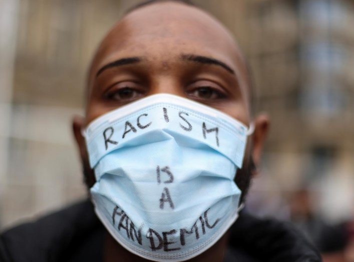 A person wearing a protective face mask attends the Black Lives Matter protest, following the death of George Floyd who died in police custody in Minneapolis, in Birmingham, Britain, June 19, 2020. REUTERS/Carl Recine