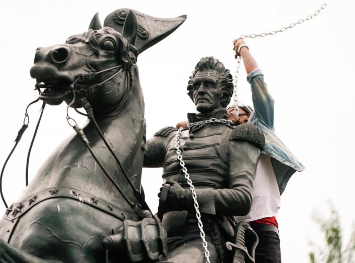 A protestor wraps chains around the neck of the statue of U.S. President Andrew Jackson during an attempt by protestors to pull the statue down in the middle of Lafayette Park in front of the White House during racial inequality protests in Washington, D.