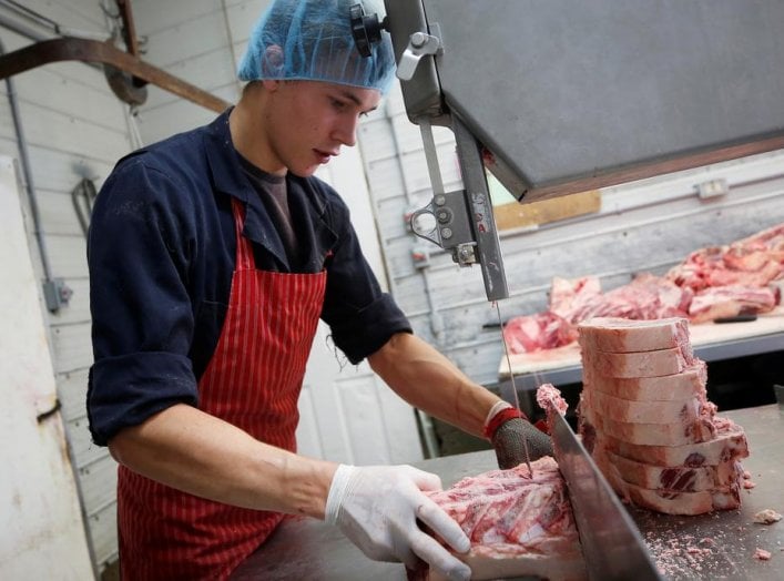 Butcher Gerald vande Bruinhorst works on a beef carcass as part of his uncle’s business which allows farmers to circumvent the supply chain blockage caused by coronavirus disease (COVID-19) outbreaks at meatpacking plants, in Picture Butte, Alberta, Canad
