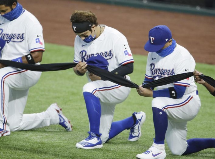 Jul 24, 2020; Arlington, Texas, USA; Texas Rangers designated hitter Shin-Soo Choo (17) and his teammates kneel before the game against the Colorado Rockies at Globe Life Field. Mandatory Credit: Tim Heitman-USA TODAY Sports