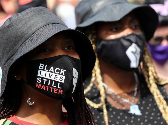 Demonstrators take part in a Black Lives Matter protest outside Tottenham police station in London, Britain August 8, 2020. REUTERS/Simon Dawson