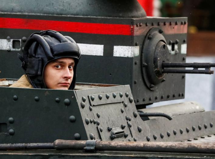 A Russian Army member rides in a historical tank, during a rehearsal for a military parade to mark the anniversary of a historical parade in 1941, when Soviet soldiers marched towards the front lines at the Red Square in Moscow, Russia November 5, 2017. R