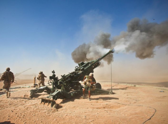 Marines with Charlie Battery, 1st Battalion, 12th Marine Regiment, fire an M982 Excalibur round from an M777 howitzer during a recent fire support mission. Afghanistan. 1 October 2011. U.S. Marine Corps.