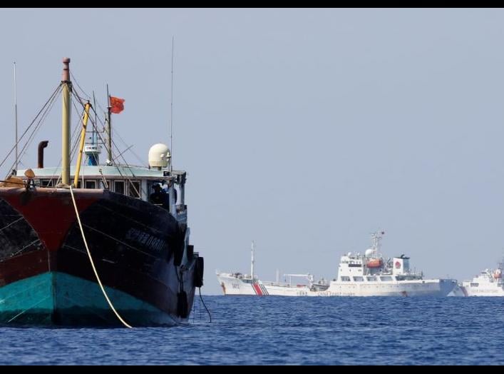 China Coast Guard vessels patrol past a Chinese fishing vessel at the disputed Scarborough Shoal, April 5, 2017. Picture taken April 5, 2017. REUTERS/Erik De Castro