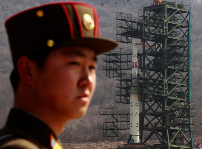 A soldier stands guard in front of the Unha-3 (Milky Way 3) rocket sitting on a launch pad at the West Sea Satellite Launch Site, during a guided media tour by North Korean authorities in the northwest of Pyongyang April 8, 2012. REUTERS/Bobby Yip (NORTH 