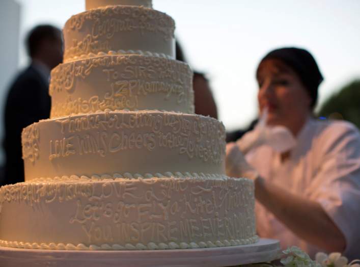 A wedding cake is decorated with messages from guests at a ceremony to celebrate the wedding of Paul Katami and Jeff Zarrillo at Beverly Hilton Hotel in Beverly Hills, California June 28, 2014. 