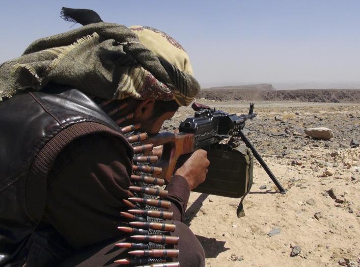 A Southern Movement militant takes aim with his machine gun as he takes part in the securing of the Jabal al-Ierr area against Shi'ite Houthi fighters, in Yemen's southern Lahej province March 7, 2015. Most of Yemen has been left without state services or