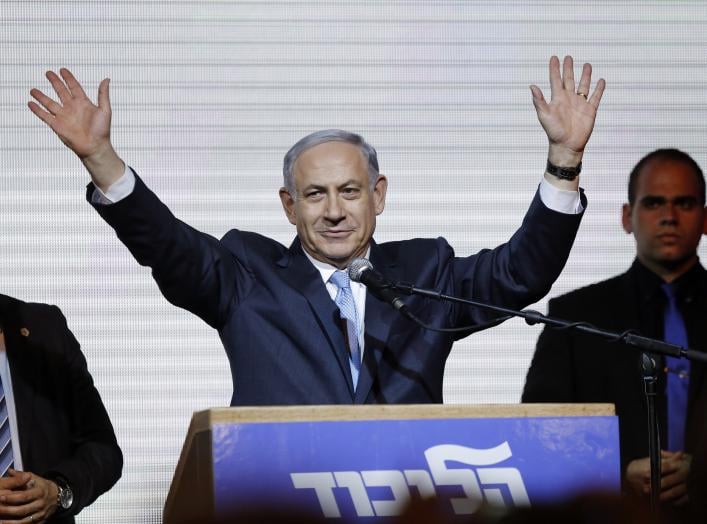Israeli Prime Minister Benjamin Netanyahu waves to supporters at the party headquarters in Tel Aviv March 18, 2015. Netanyahu claimed victory in Israel's election after exit polls showed he had erased his center-left rivals' lead with a hard rightward shi