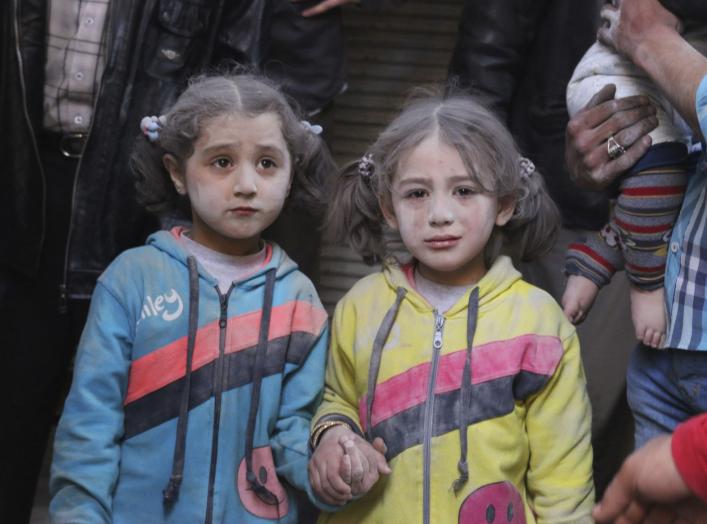Girls who survived what activists said was a ground-to-ground missile attack by forces of Syria's President Bashar al-Assad, hold hands at Aleppo's Bab al-Hadeed district April 7, 2015. REUTERS/Abdalrhman Ismail TPX IMAGES OF THE DAY