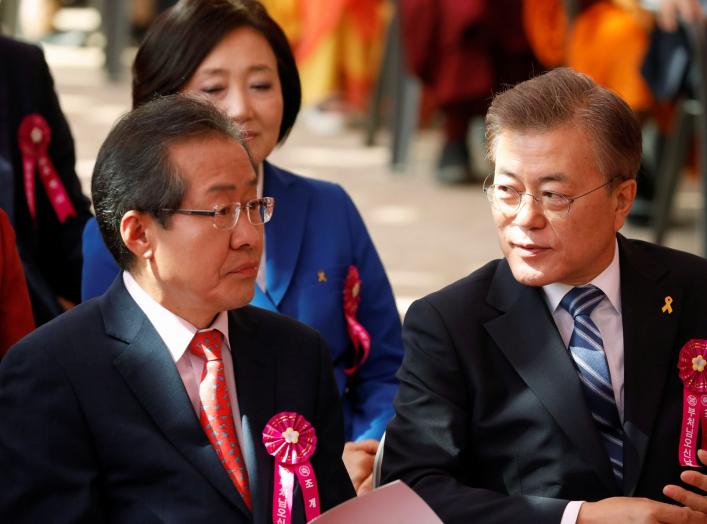 Moon Jae-in (R), presidential candidate of the Democratic Party of Korea, talks with Hong Joon-pyo, presidential candidate of the Liberty Korea Party, during a ceremony celebrating the birthday of Buddha at Jogye temple in Seoul, South Korea, May 3, 2017.