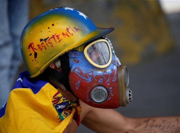 A demonstrator looks on while clashing with riot security forces during a rally against Venezuela's President Nicolas Maduro's government in Caracas, Venezuela, August 12, 2017. REUTERS/Andres Martinez Casares 
