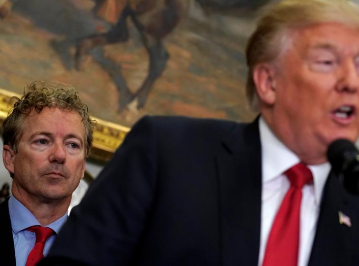 U.S. Senator Rand Paul (R-KY) listens as U.S. President Donald Trump speaks before signing an executive order making it easier for Americans to buy bare-bones health insurance plans and circumvent Obamacare rules at the White House