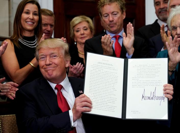 U.S. President Donald Trump smiles after signing an Executive Order to make it easier for Americans to buy bare-bone health insurance plans and circumvent Obamacare rules at the White House in Washington, U.S., October 12, 2017. REUTERS/Kevin Lamarque TPX