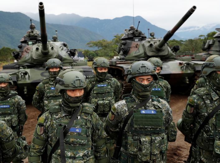 Taiwanese soldiers stand in front of M60A3 tanks during a military drill in Hualien, eastern Taiwan, January 30, 2018. REUTERS/Tyrone Siu