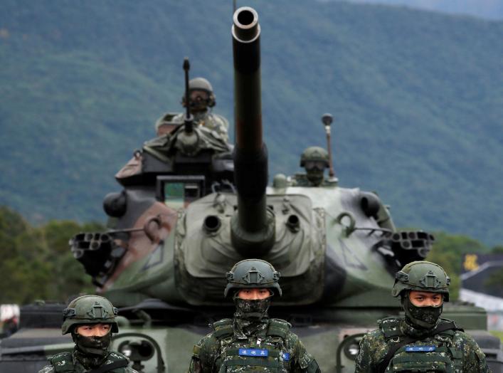 Taiwanese soldiers stand in front of a M60A3 tank during a military drill in Hualien, eastern Taiwan, January 30, 2018. REUTERS/Tyrone Siu