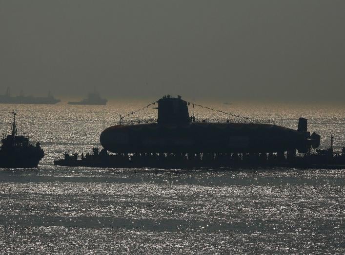 India's third Scorpene-class submarine INS Karanj is seen silhouetted as a tugboat pulls it during its launch at the Mazagon Dock Ltd. naval shipbuilding yard, in Mumbai, India January 31, 2018. REUTERS/Shailesh Andrade TPX IMAGES OF THE DAY