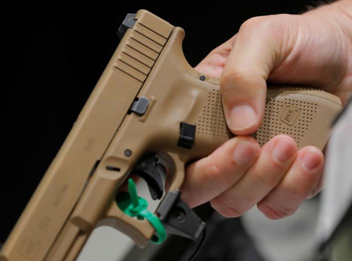 A man holds a Glock handgun during the annual National Rifle Association (NRA) convention in Dallas, Texas, U.S., May 6, 2018. REUTERS/Lucas Jackson