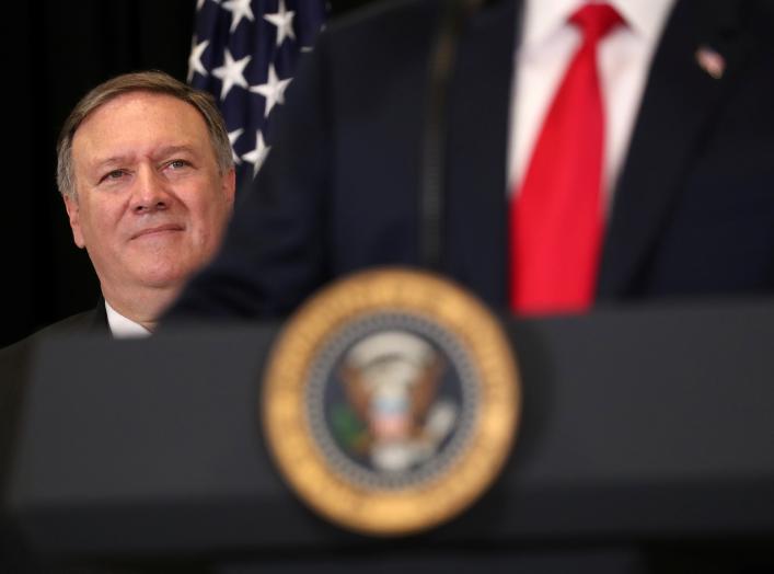U.S. President Donald Trump is watched by Secretary of State Mike Pompeo as they take part in the swearing-in ceremony for the Central Intelligence Agency's first female director, Gina Haspel, at CIA Headquarters in Langley, Virginia, U.S., May 21, 2018. 